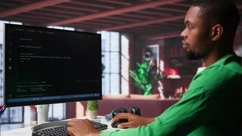 Male programmer types code on computer and running script Video stock 307796816