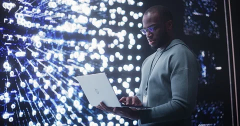 Male Programmer Typing and Looking at Data on Big Screen Stock Footage 243288473
