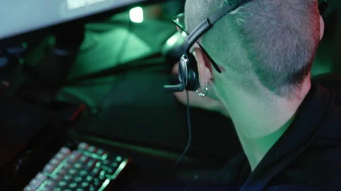Male programmer typing on backlit keyboard in a dark room Stock Footage 341658694