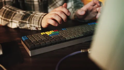 Male programmer typing on computer keyboard, troubleshooting software bugs Stock Footage 315455947