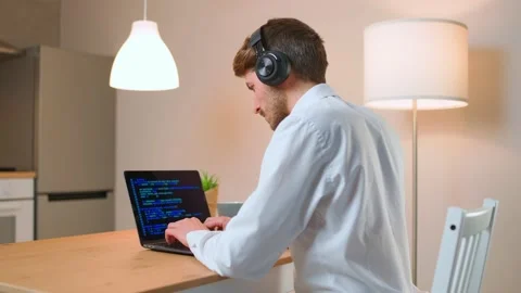 Male programmer is working on creating software, typing program code on a laptop Stock Footage 151944908
