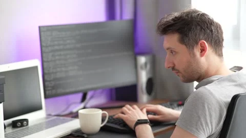 Male programmer working at home. Programmer coding from home office. Video stock 183073138