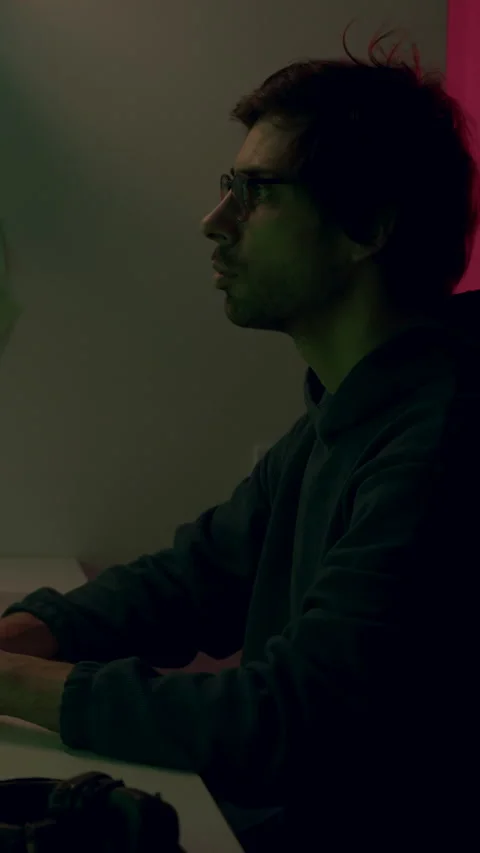 Male programmer working intently at a modern workstation with multiple screens Stock Footage 315441492