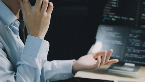 Male programmer working on new project.He working late at night at the office Stock Footage 312244085