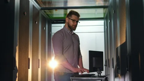 Male programmer works with computer in server room. Stock Footage 118615855