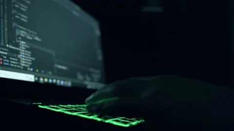 Male programmer writes program code on a laptop. close-up. night. Stock Footage 233847180