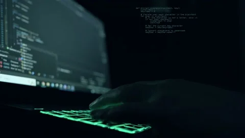 Male programmer writes program code on a laptop. close-up. night Stock Footage 234120187