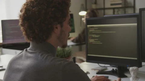 Male Programmer Writing Code on Desktop Computer Stock Footage 255782077