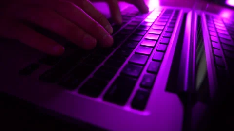 A male programmer writing code on a keyboard. Stock Footage 277360736