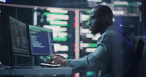 Male Programmer Writing Code Surrounded by Big Screens Video stock 243286699