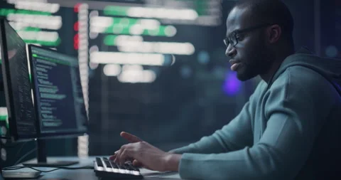 Male Programmer Writing Code Surrounded by Big Screens Video stock 243286763