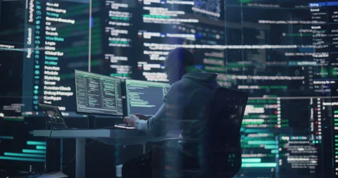 Male Programmer Writing Code Surrounded by Big Screens Stock Footage 243287516