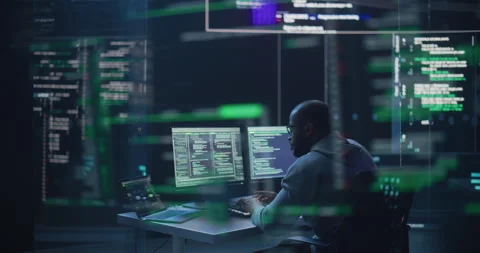 Male Programmer Writing Code Surrounded by Big Screens Video stock 243287712