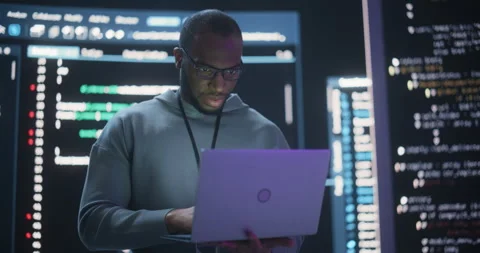 Male Programmer Writing Code Surrounded by Big Screens Video stock 243289309