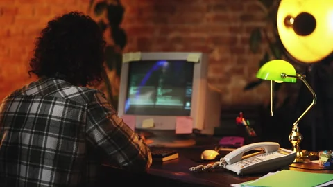 Male programmer writing code on vintage computer, developing software, 80s style Stock Footage 321084779