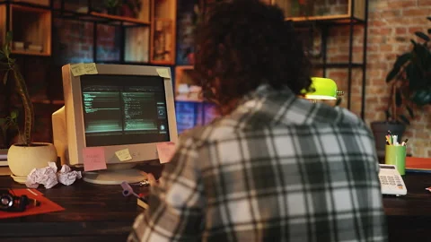 Male programmer writing computer code in 90s office, retro technologies scene Stock Footage 315456768