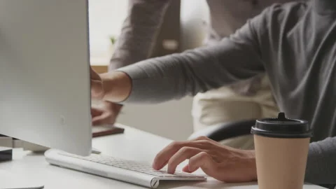 Male Programmers Discussing Computer Program in Office Stock Footage 255783869