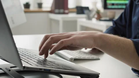 Male Programmers Hands Entering Code on Computer and Laptop at Office Desk Stock-Footage 330668042