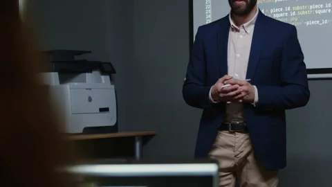 Male Programming Teacher Asking Question to Unrecognizable Student in Class Stock Footage 278125770