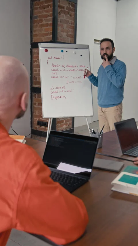 Male Programming Teacher Explaining Coding Concepts to Convict in Jail Stock Footage 314052236
