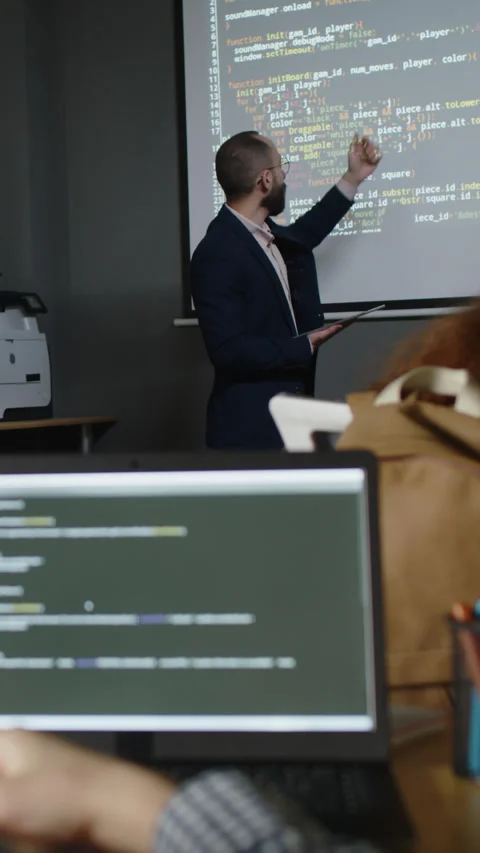 Male Programming Teacher Explaining New Topic to Students at Lesson Stock Footage 278584527