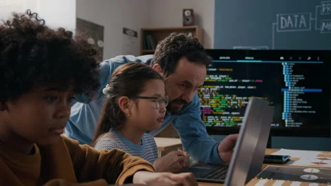 Male Programming Teacher Helping Young Asian Girl Struggling with Algorithm Stock-Footage 306933744