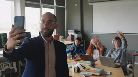 Male Programming Teacher with Smartphone Taking Selfie with his Students Stock Footage 278128555