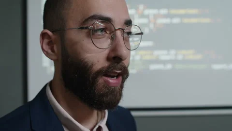 Male Programming Teacher Talking to Class in front of Screen with Code Stock Footage 278125542