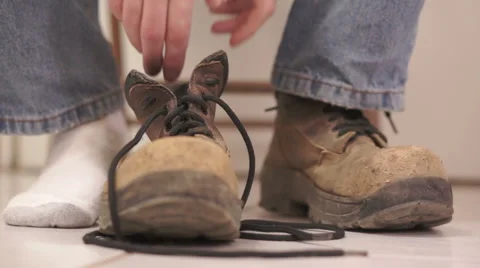 Male Putting On Old Workboot Stock Footage 46152807
