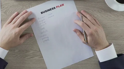 Male putting question mark next to business plan elements, balling paper, doubts Stock Footage 76766531