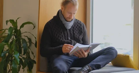 Male read book in library Stock Footage 122339812