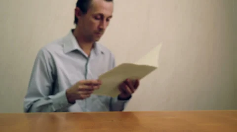 Male Reading and Throwing File Folder Stock Footage 39809727