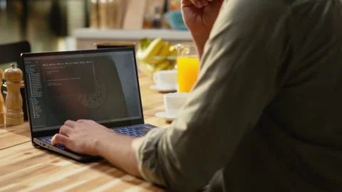 Male remote coder developing binary code to build software systems on laptop Stock Footage 330440854