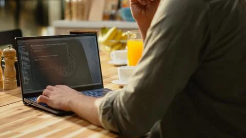 Male remote coder developing binary code to build software systems on laptop Foto stock