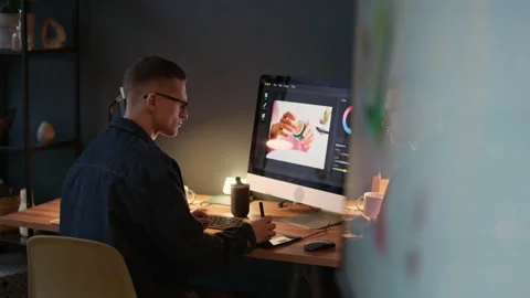 Male Retoucher Using Computer to Edit Photo Stock Footage 329509794