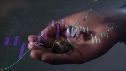 Male right hand receiving falling coins, collecting while finance graphs Stock Footage 334311579