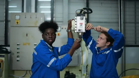 Male Robotics engineer working with Programming and Manipulating Robot Hand Stock Footage 280791203