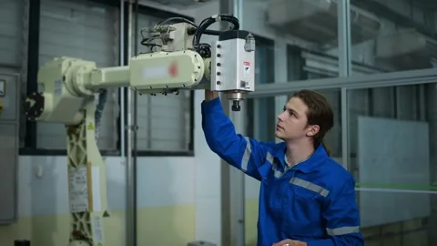 Male Robotics engineer working with Programming and Manipulating Robot Hand Stock Footage 280791224