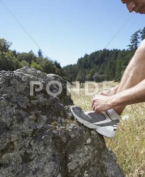 Male runner adjusting shoe lace Stock Photos