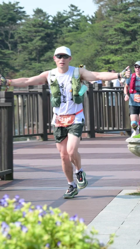 Male Runner with Arms Spread and Thumbs Up on Lake Boardwalk, Lushan Stock Footage 346716487