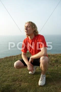 A Male Runner Crouches