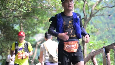 Male Runner on Forest Stone Path Past Spectators, Lushan Trail 스톡 동영상 346718582