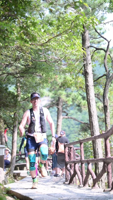 Male Runner with Green Compression Socks on Stone Trail, Lushan Stock Footage 346716614