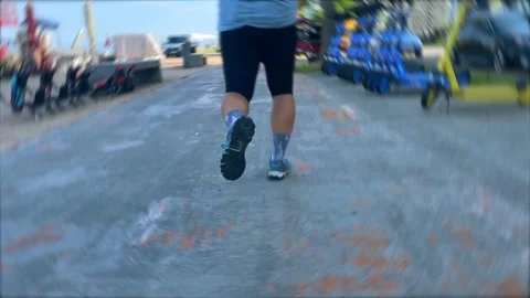 Male runner jogging from rear close-up along Batumi promenade Stock Footage 346743147