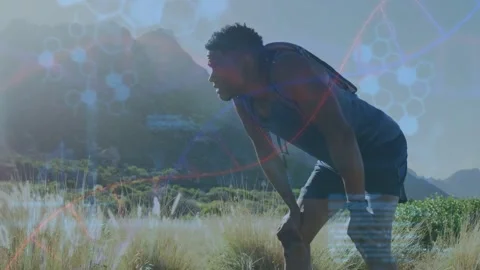 Male runner pausing hill glancing wrist device and activating DNA overlays Stock Footage 333414082