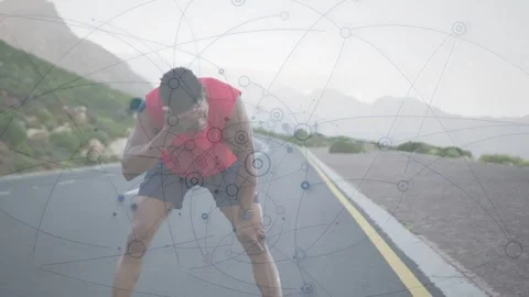 Male runner pausing on mountain road, recovering and initiating fitness HUD Stock Footage 333789811