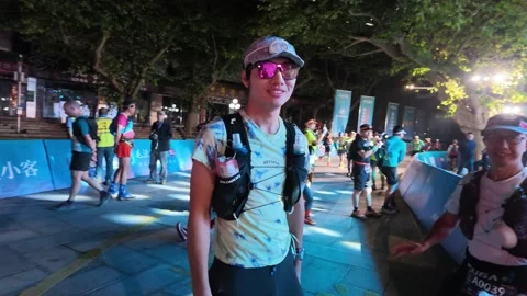 Male Runner Posing Hands on Hips Before LED Stage at Night, Lushan Stock-Footage 346701761