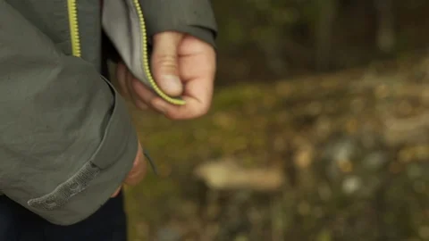Male runner pulling zip on sport jacket Otago Video stock 112963175