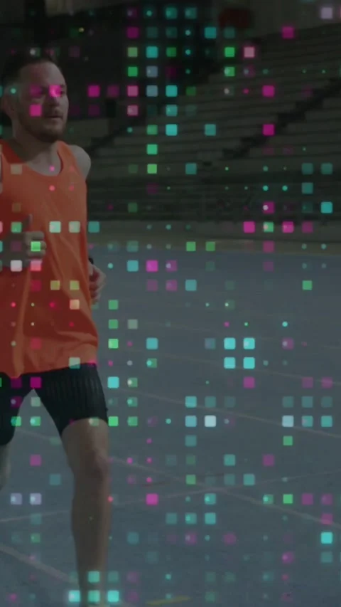 Male runner starting lap, running across arena, pixel overlay showing running Stock Footage 334397241