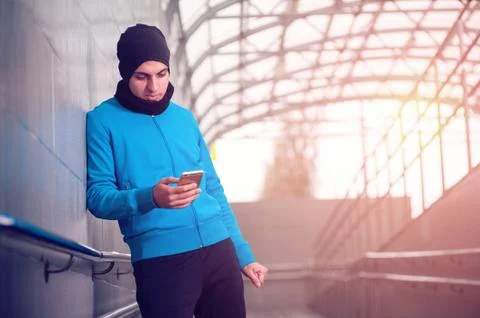 Male runner using smartphone workout app Stock Photos